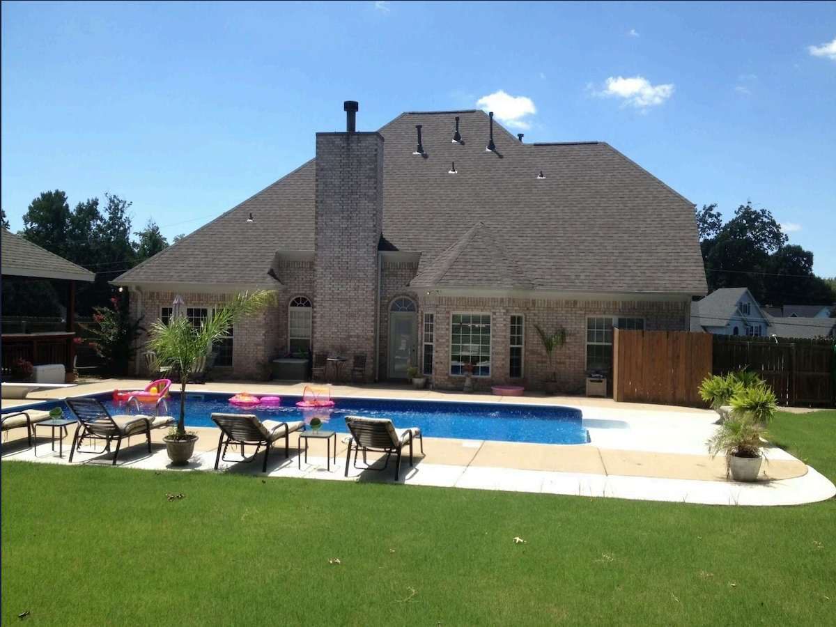 The Horn Lake crew house seen from the back lawn, with its private pool and covered cabana.